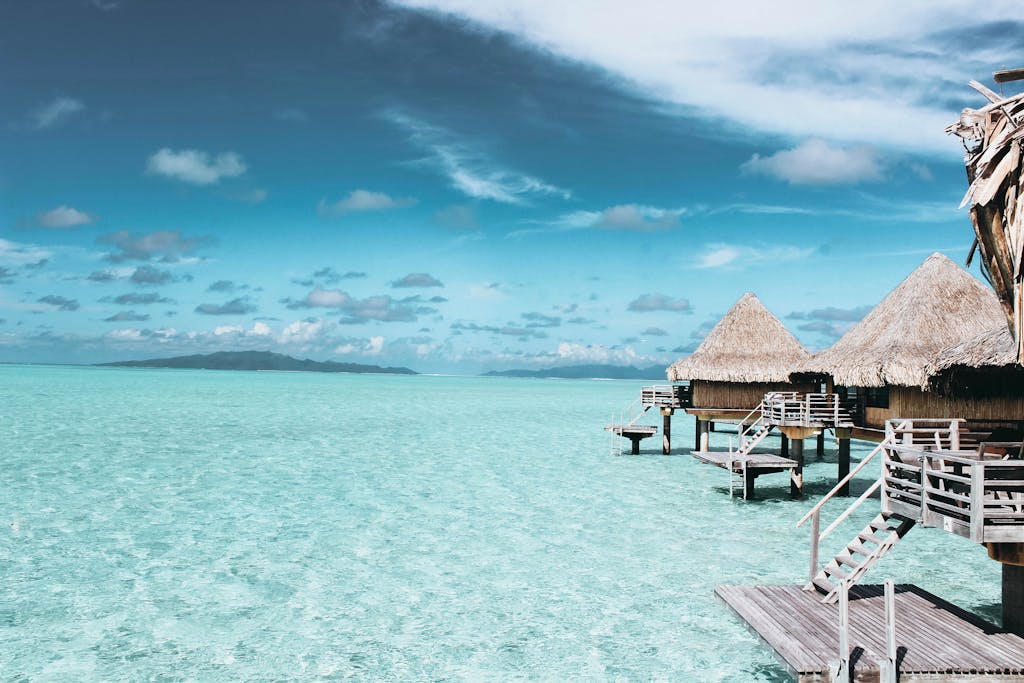 Overwater bungalows on a crystal-clear turquoise sea in French Polynesia.