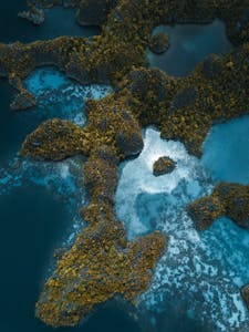 Breathtaking aerial shot of Raja Ampat Islands, showcasing stunning geological formations and vibrant waters.